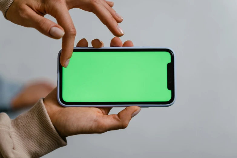 a person holding a smart phone with a green screen, by Adam Marczyński, trending on pexels, square, on a gray background, green stained glass, rounded corners