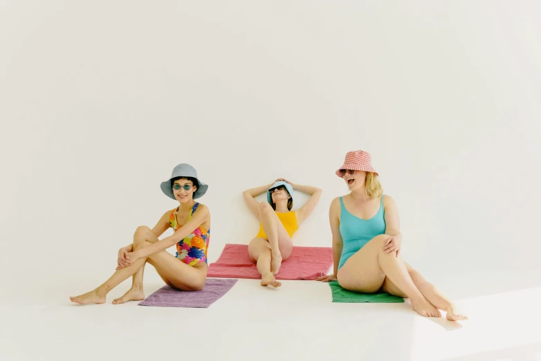 a group of women sitting on top of a white floor, unsplash, figuration libre, wearing wide sunhat, bright in colour, 3 - piece, pale-skinned