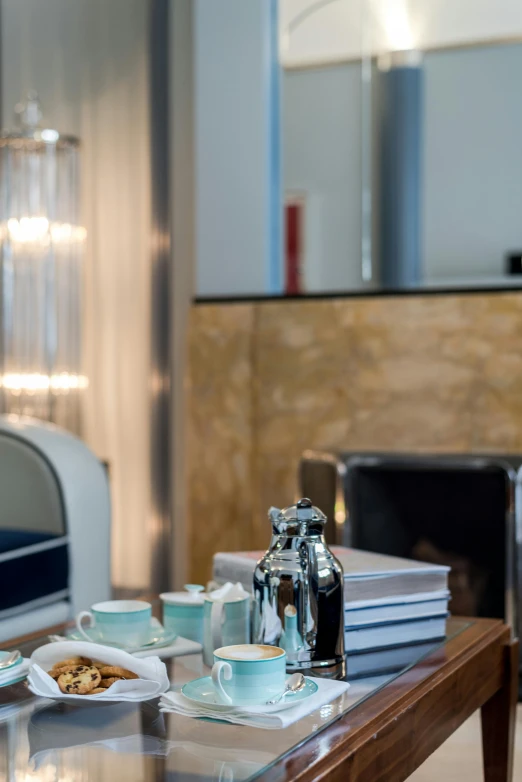 a glass table topped with plates of food, by Carlo Martini, happening, serene bedroom setting, pair of keycards on table, silver and blue color schemes, 3/4 side view