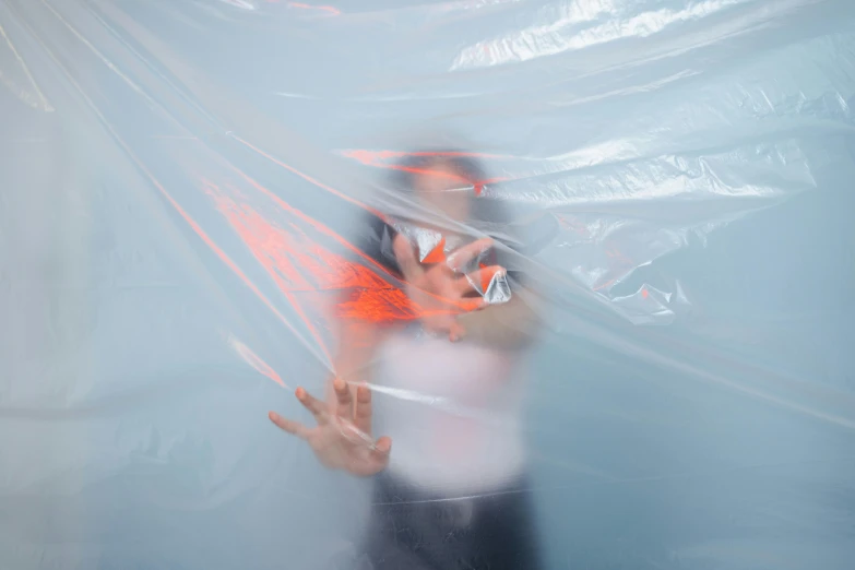 a blurry image of a person talking on a cell phone, a hologram, by Jessie Algie, unsplash, interactive art, wearing a plastic garbage bag, tickle fight in the death tent, emanating magic from her palms, with a white background