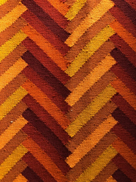 a colorful area rug with a zig zag pattern, inspired by Anni Albers, pexels contest winner, symbolism, dark oranges reds and yellows, 2 5 6 x 2 5 6 pixels, wooden parquet, detail texture