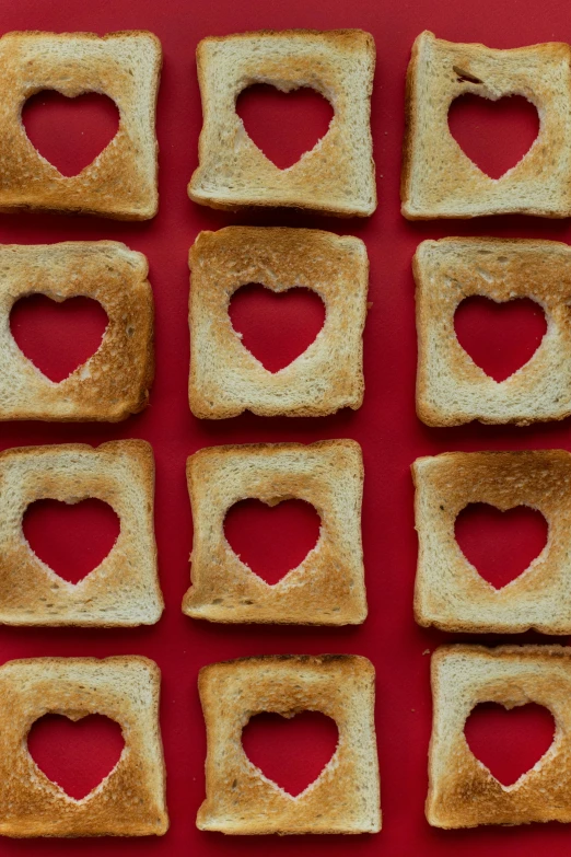 heart shaped toast squares on a red surface, trending on pexels, light - hearted, with bread in the slots, graphic”, 12