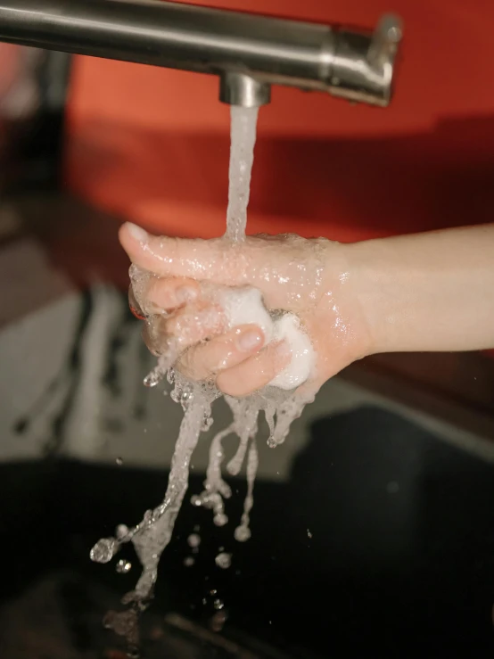 a person washing their hands in a sink, a stipple, pexels, thumbnail, dry ice, profile image, raising an arm