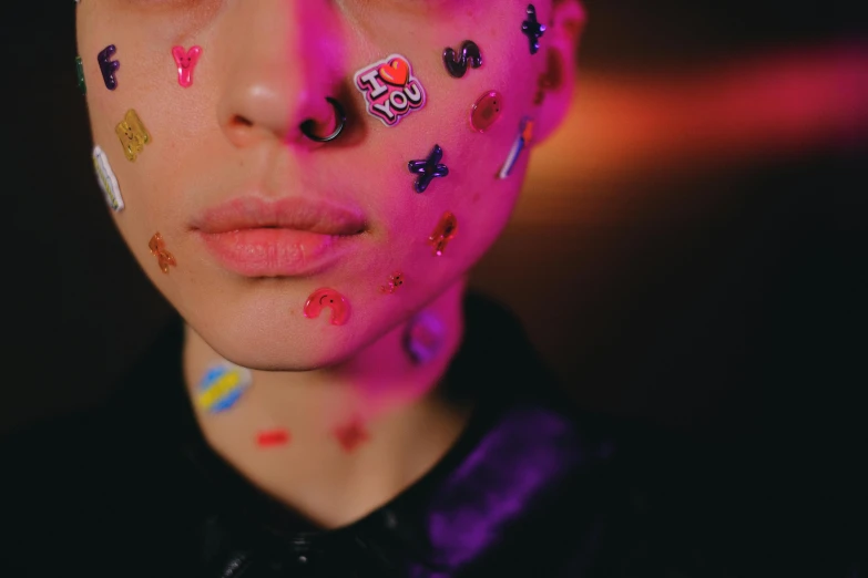 a close up of a person with tattoos on their face, an album cover, by Julia Pishtar, trending on pexels, colorful dots, bisexual lighting, sticker - art, yoh yoshinori