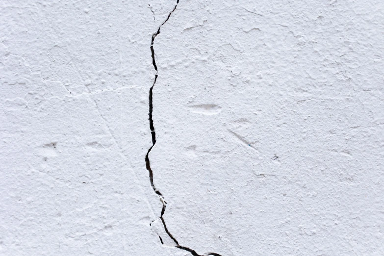 a crack in the side of a white wall, inspired by Lucio Fontana, pexels, background image, earthquake, technical, enamel