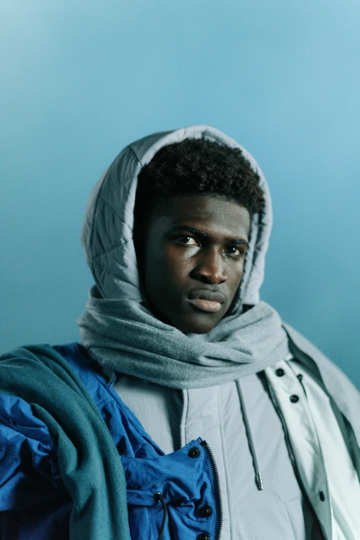 a close up of a person wearing a hoodie, inspired by Paul Georges, model wears a puffer jacket, ( ( dark skin ) ), promo still, edward buba