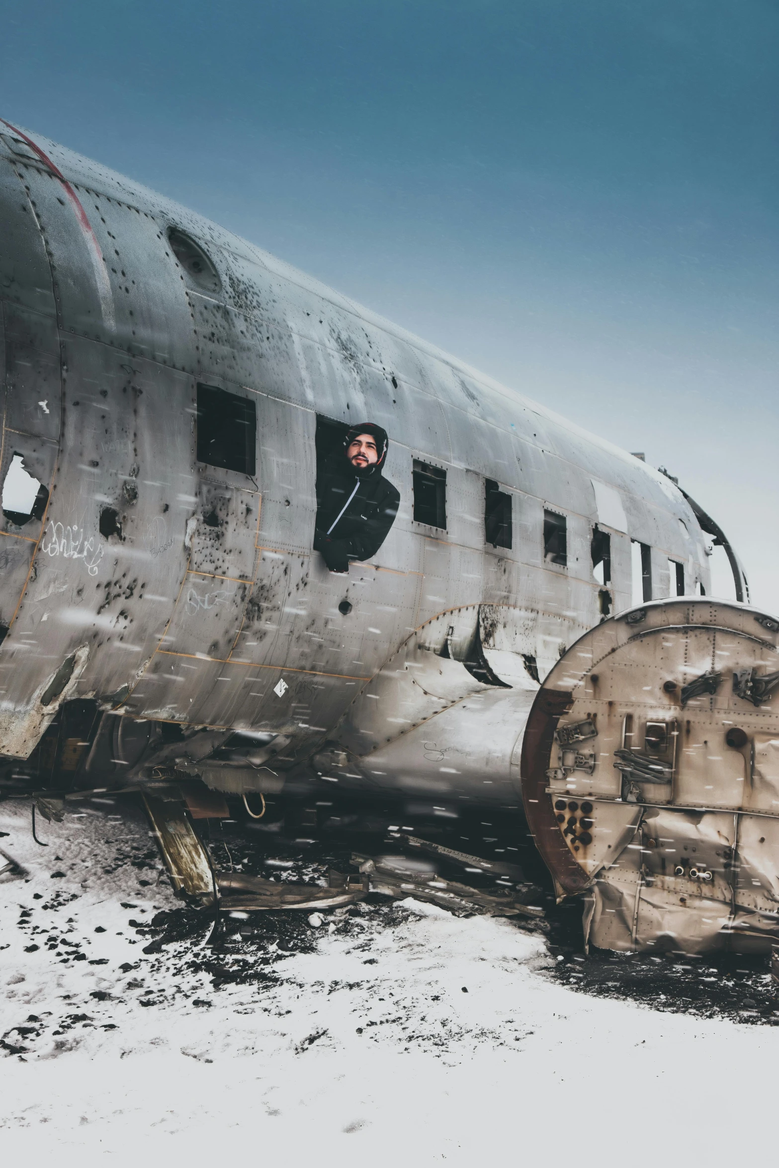 a large airplane sitting on top of a snow covered field, an album cover, pexels contest winner, standing in a space ship wreck, portrait photo, tourist photo, a handsome