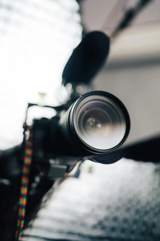 a close up of a camera on a tripod, unsplash, video art, view from a news truck, looking up at camera, long lens, studio photo