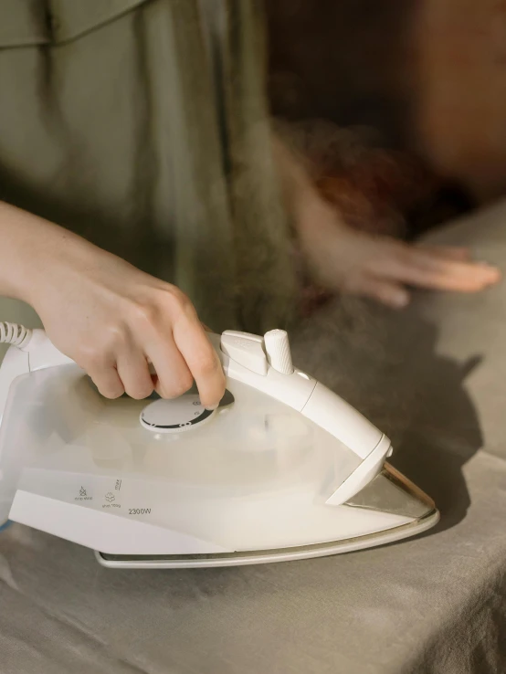 a woman ironing on an iron on a table, by Robbie Trevino, splash image, soft white rubber, high quality image, alessio albi