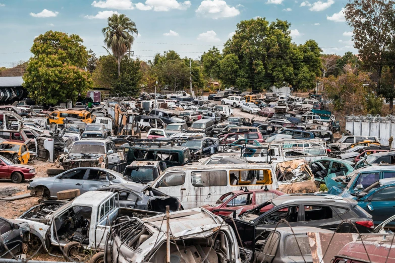 a parking lot filled with lots of old cars, a portrait, unsplash, auto-destructive art, unmistakably kenyan, mining scrap metal, “ iron bark, 2000s photo