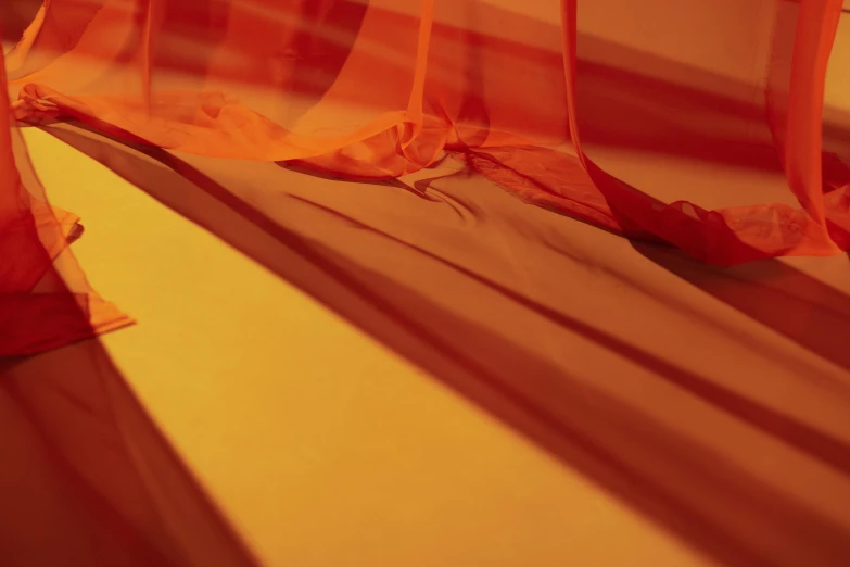 a close up of a curtain on a window sill, inspired by Christo, unsplash, gutai group, orange and red lighting, on the orange surface of mars, sails, wide ribbons