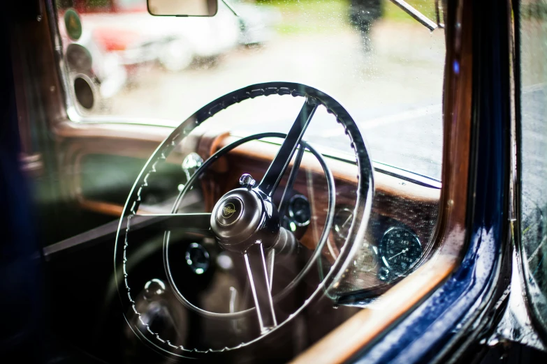 a close up of a steering wheel in a car, by Tom Bonson, unsplash, renaissance, vintage aston martin, a wooden, dressed in a worn, 15081959 21121991 01012000 4k