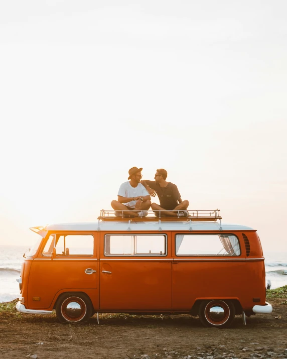 two people sitting on top of an orange van, pexels contest winner, summer of love, manly, deus ex machina, chemistry