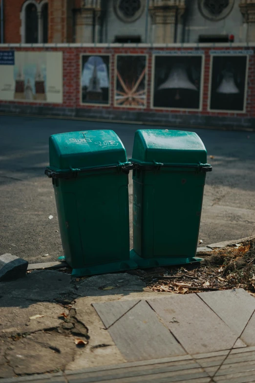 two green trash cans sitting on the side of a road, an album cover, unsplash, paul barson, neighborhood, dug stanat, kreuzberg