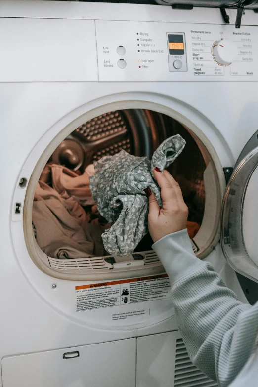 a person putting a cloth in a washing machine, profile image, ✨🕌🌙, grey clothes, poop