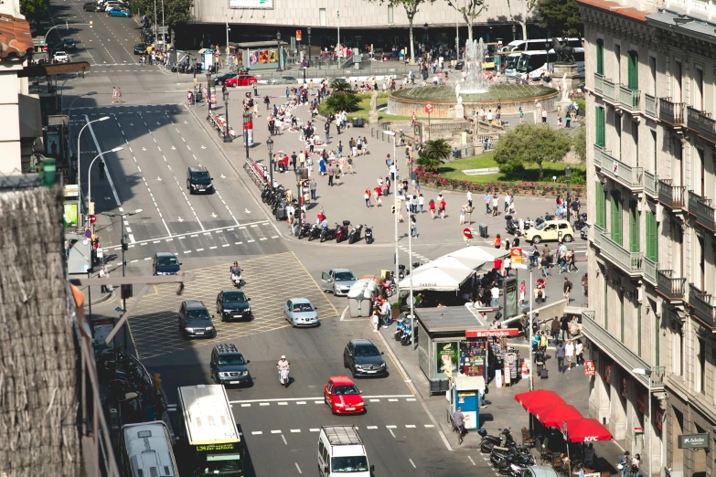 a city street filled with lots of traffic next to tall buildings, barcelona, birdseye view, cars and people, thumbnail