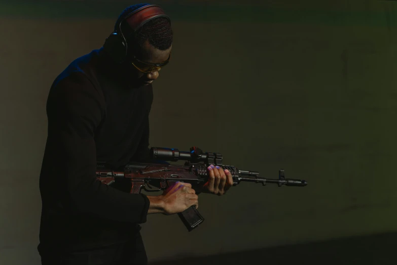 a man in a black shirt holding a gun, softair arena landscape, photo from the olympic games, ( ( dark skin ) ), red weapon 8 k s 3 5