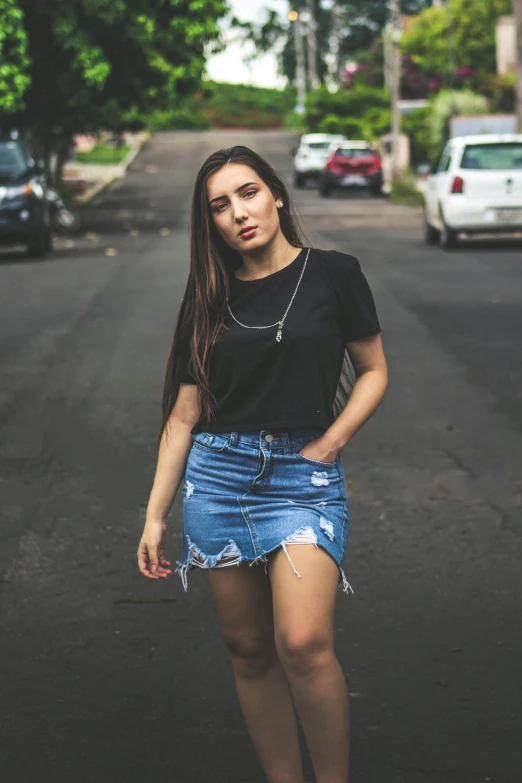 a woman standing in the middle of a street, wearing a black tshirt, torn shorts, profile image, pokimane