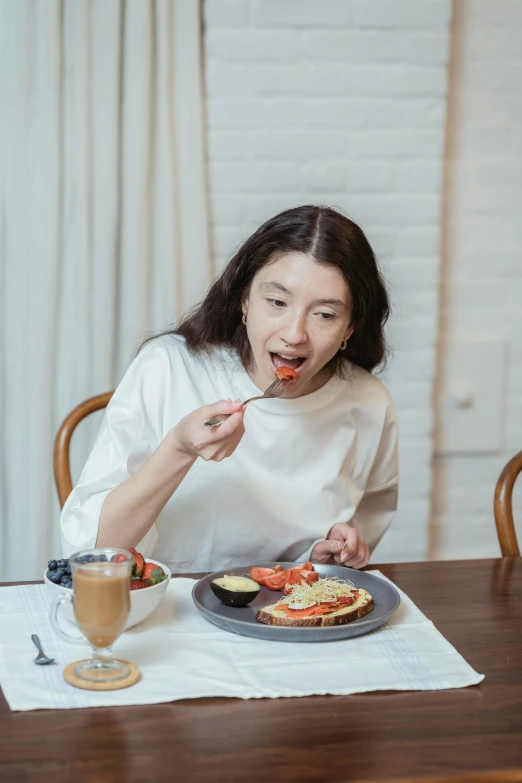 a woman sitting at a table with a plate of food, long tongue, profile image, 2019 trending photo, korean