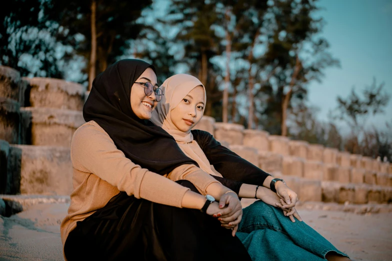 a couple of women sitting next to each other, pexels contest winner, hurufiyya, avatar image, modest, embracing, high quality image