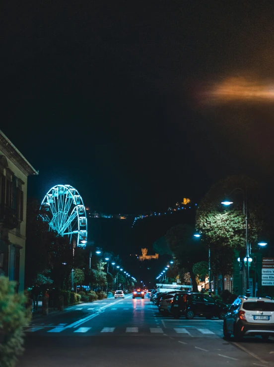 a city street at night with a ferris wheel in the background, by Robbie Trevino, background image, high quality image