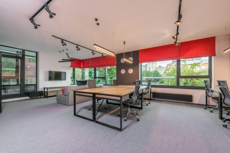 a conference room with a table and chairs, by Emma Andijewska, unsplash, bauhaus, soft grey and red natural light, lush surroundings, black and red suit, in a open-space working space