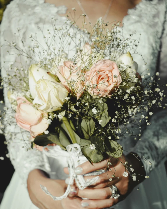 a woman in a wedding dress holding a bouquet of flowers, trending on unsplash, non-binary, dua lipa, holding each other, silver，ivory