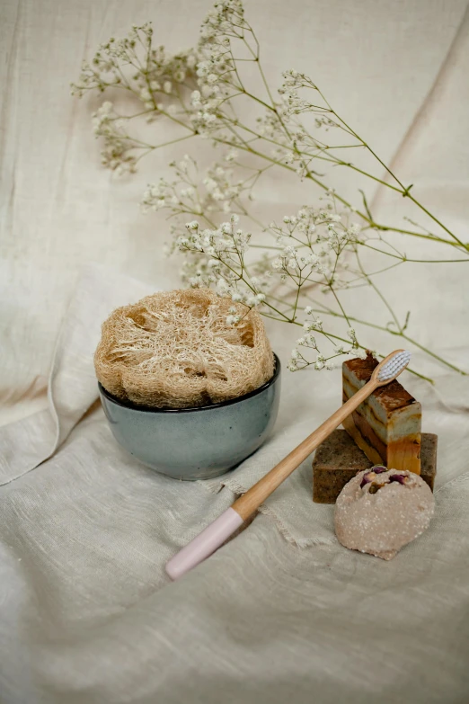 a close up of a bowl of food on a table, a still life, by Henriette Grindat, unsplash, renaissance, carved soap, wetbrushes, made of dried flowers, voluptuous sesame seed bun