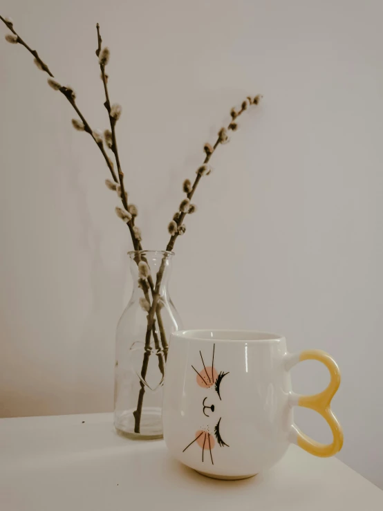 a couple of vases sitting on top of a table, by Dulah Marie Evans, white mug, yellow beak, close-up product photo, glasses |