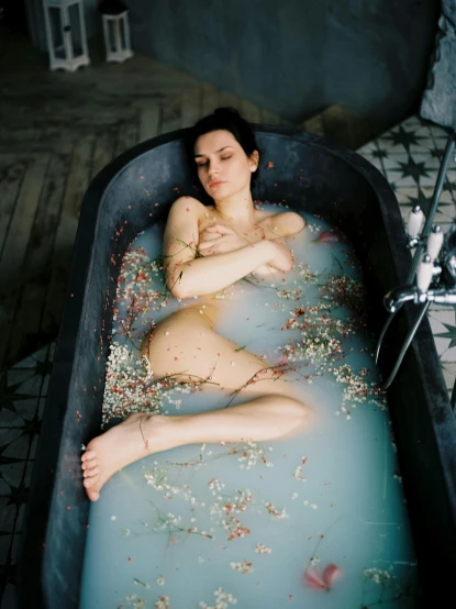 a woman laying in a bathtub filled with confetti, inspired by Elsa Bleda, renaissance, maxim sukharev, 4 k photo autochrome, ilustration, pale gray skin