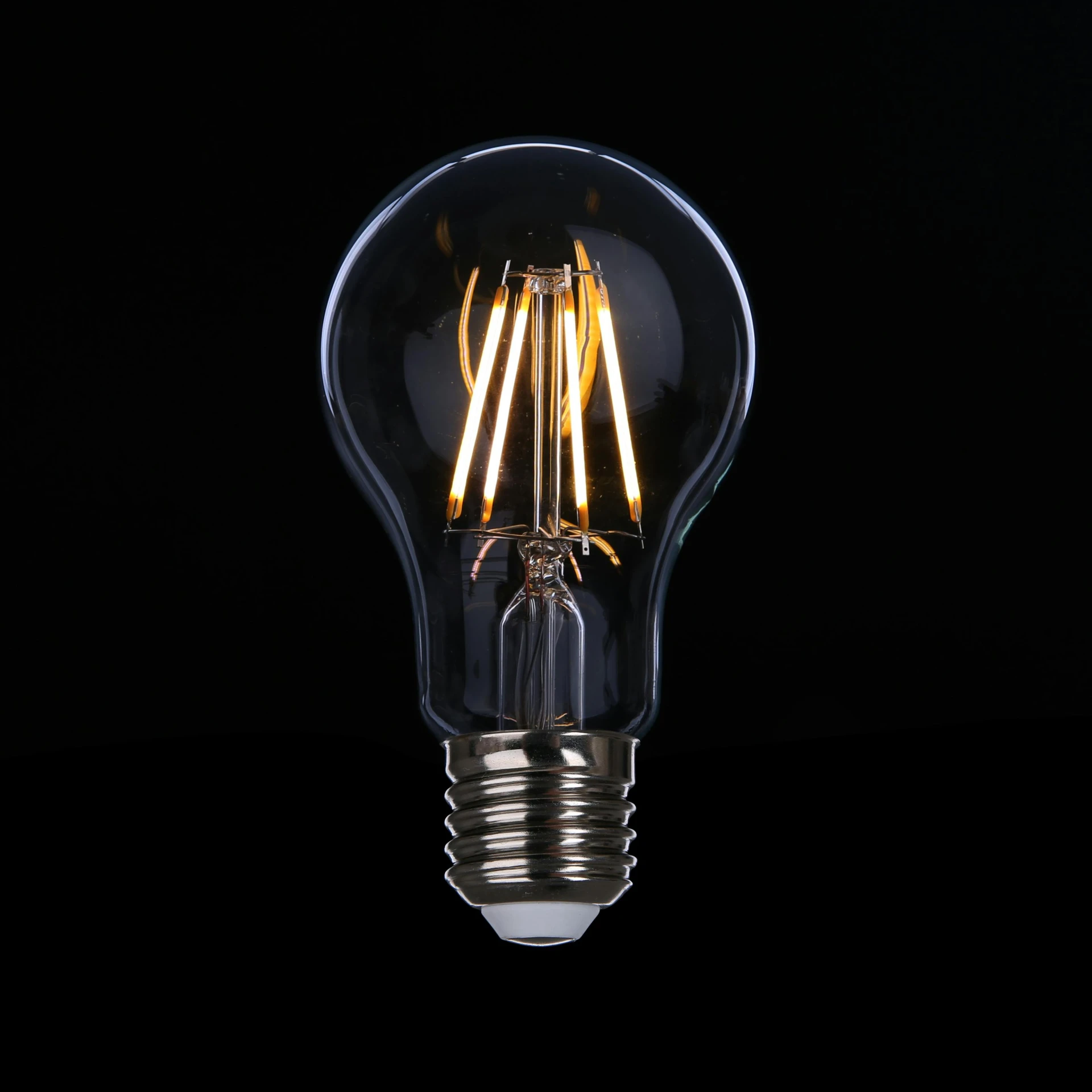 a close up of a light bulb on a black background, inspired by George Fiddes Watt, pexels, decoration, led lights, vintage style, apple