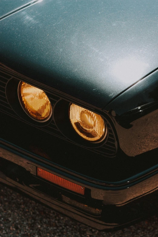 a green car parked on the side of the road, an album cover, by Adam Rex, pexels contest winner, photorealism, round headlights, bmw e 3 0, yellow light, closeup shot of face