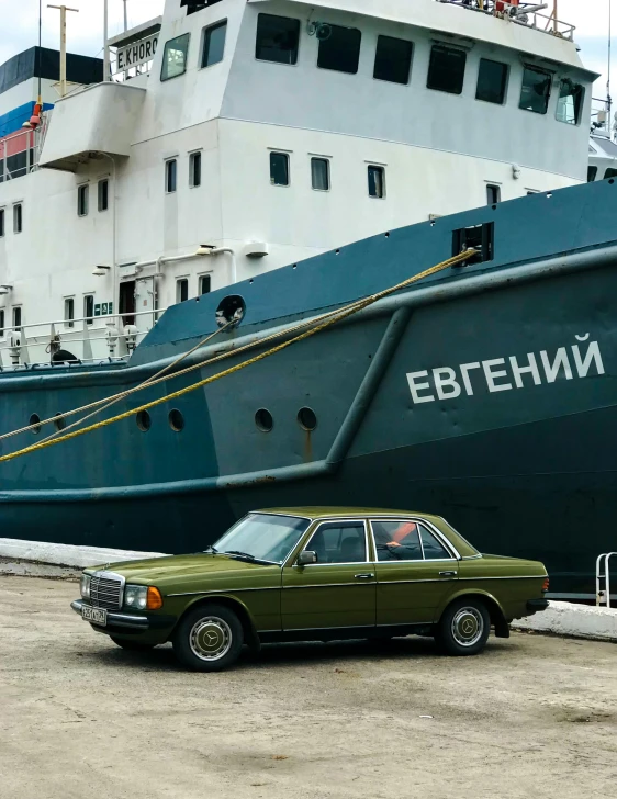 a car is parked in front of a boat, an album cover, by Sven Erixson, pexels contest winner, socialist realism, olive green, russian, 🚿🗝📝, an olive skinned