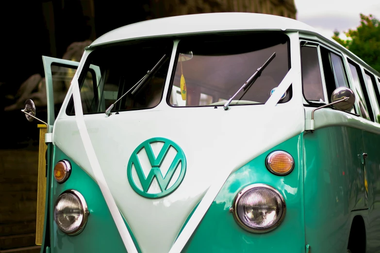 a green and white vw bus parked in a parking lot, by Tom Bonson, pexels contest winner, closeup photo, groovy vibe, teal, avatar image