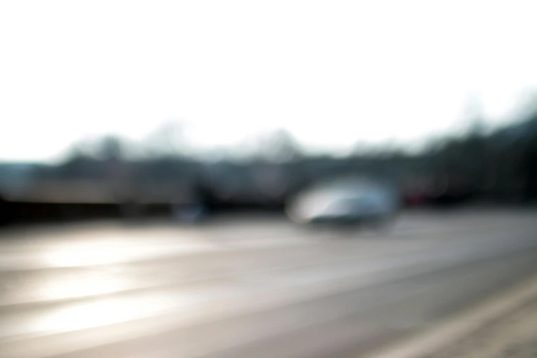 a blurry picture of cars on a highway, by Michael Sittow, visual art, background image, midday photograph, barely visible, some of the blacktop is showing