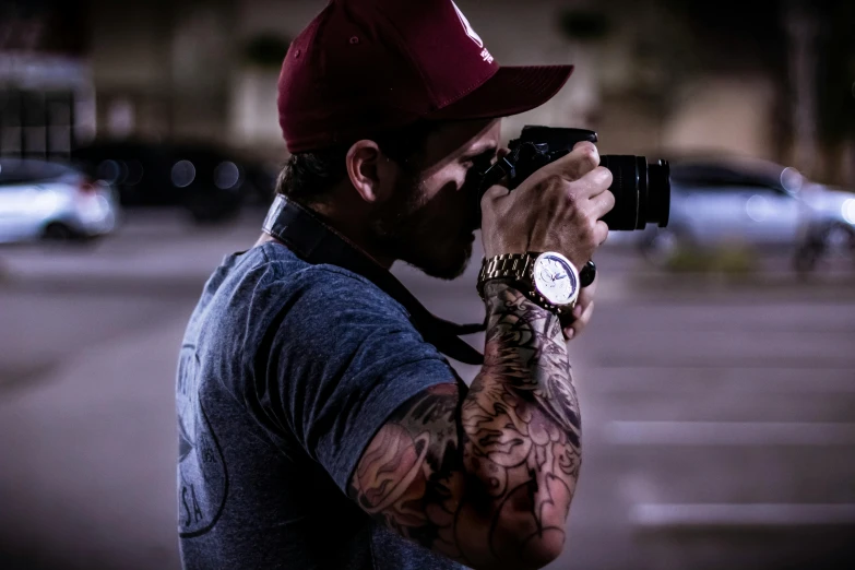 a man taking a picture with a camera, a tattoo, profile image, late night, professional photo-n 3, high quality action photography