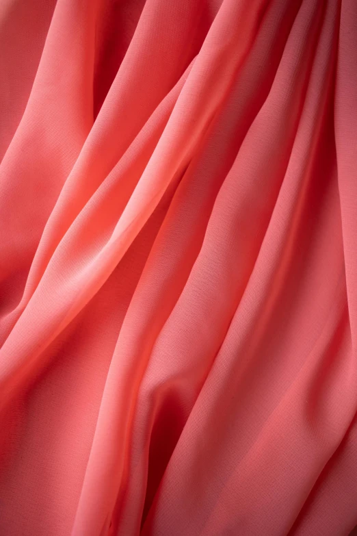 a close up shot of a pink fabric, inspired by Carlo Randanini, trending on pexels, coral red, flowing gown, double layer fold over hem, chiffon