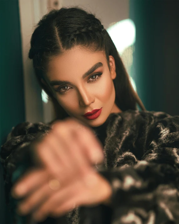 a woman in a fur coat pointing at the camera, trending on pexels, hurufiyya, dark hair and makeup, ameera al taweel, slicked-back hair, lgbtq