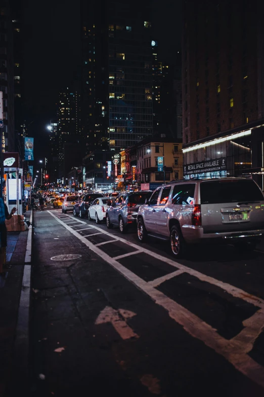a city street filled with lots of traffic at night, street of new york, unsplash photography, square, low quality photo