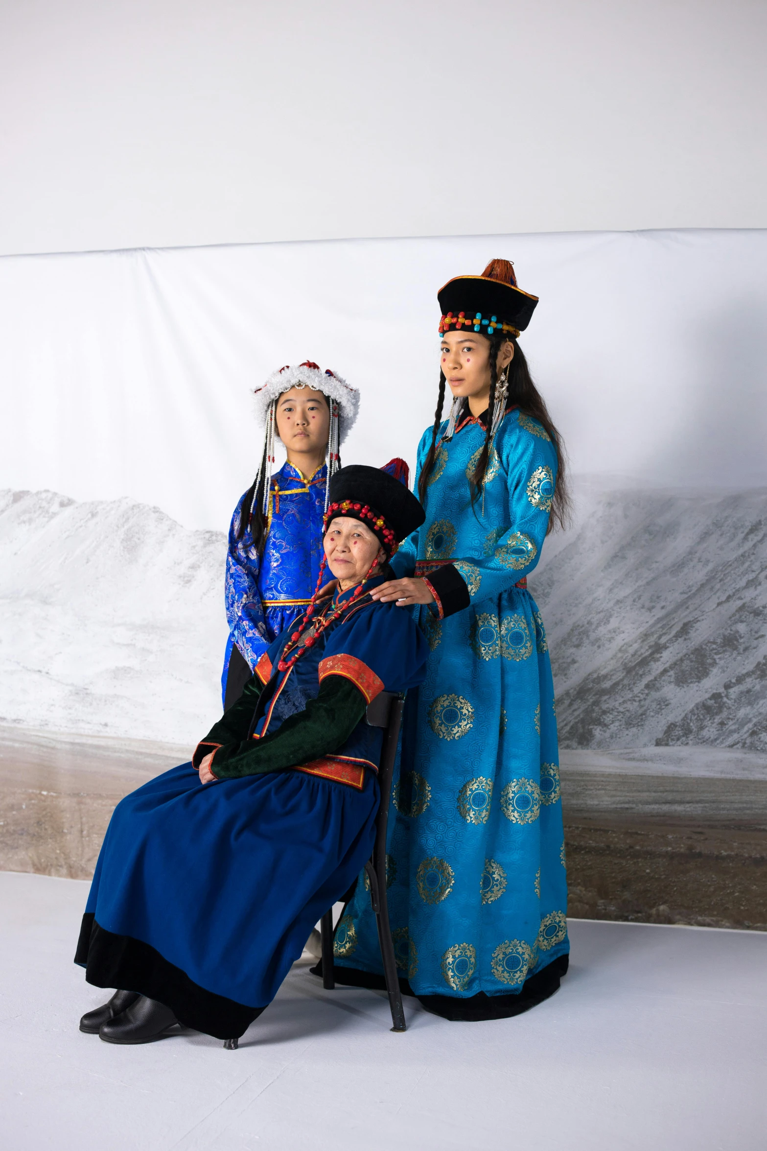 a couple of people standing next to each other, inspired by Guo Xi, unsplash, gutai group, russian costume, three women, arctic, in front of white back drop