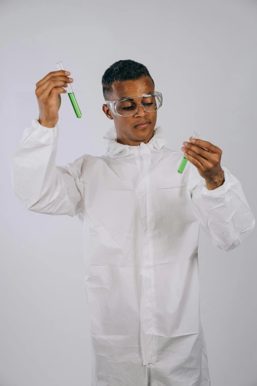 a man in a lab coat holding a green tube, unsplash, process art, afro tech, 4 0 0 0 samples, wearing nanotech honeycomb robe, plain background