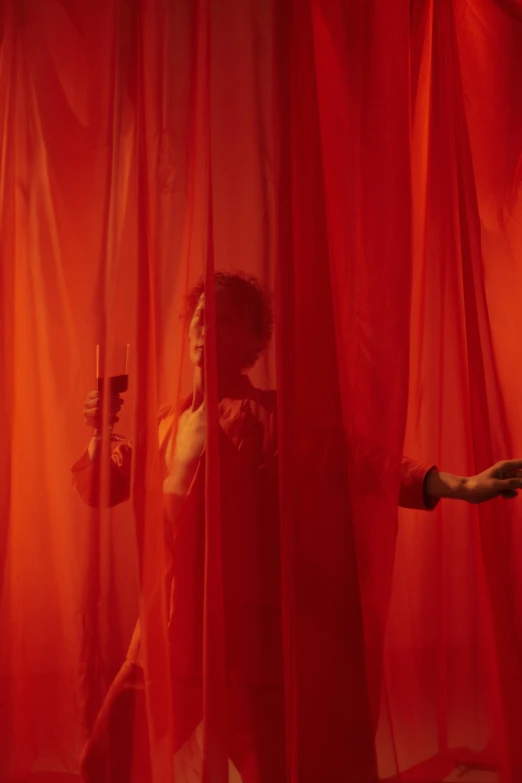 a woman standing in front of a red curtain, inspired by Carrie Mae Weems, pexels contest winner, conceptual art, remedios varo uranga, showstudio, ( ( theatrical ) ), concert