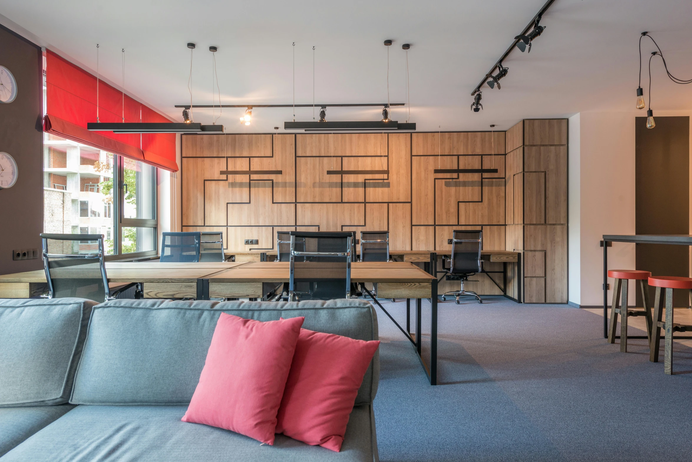 a living room with a couch a table and chairs, by Adam Marczyński, light and space, office cubicles, accents of red, wooden interior, thumbnail