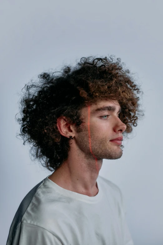 a man with curly hair wearing a white shirt, an album cover, inspired by Alexis Grimou, trending on pexels, boy thin face, profile portrait, integrated synthetic android, adam ondra