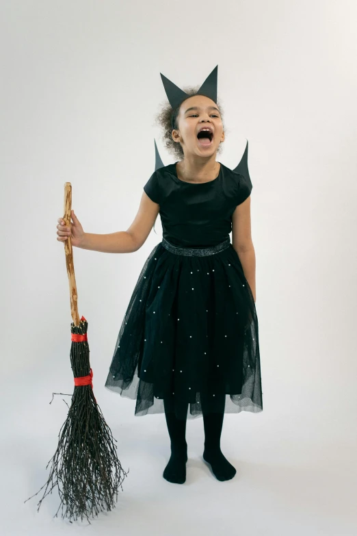 a little girl dressed up as a witch with a broom, by Winona Nelson, jen atkin, wearing spiky, diy, medium