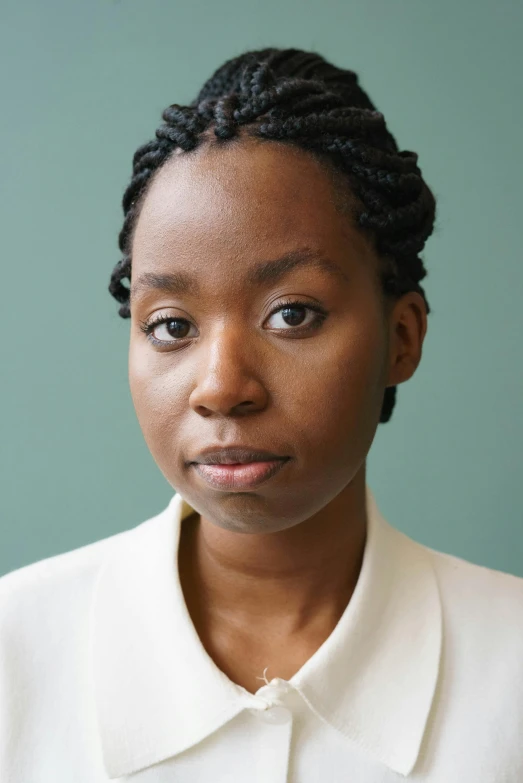 a close up of a person wearing a white shirt, by Lily Delissa Joseph, looking serious, representative portrait, african, hammershøi