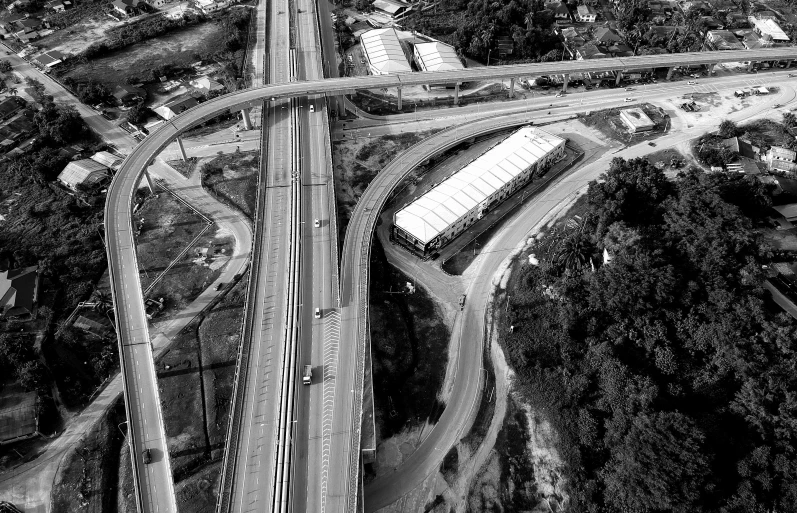 a black and white photo of a highway intersection, a black and white photo, pexels, aerial footage, são paulo, set photo, brown