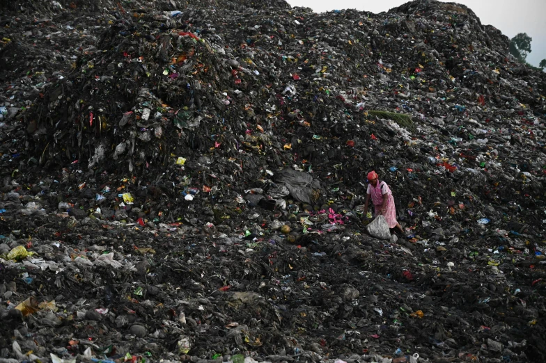 a woman standing on top of a pile of garbage, reuters, avatar image