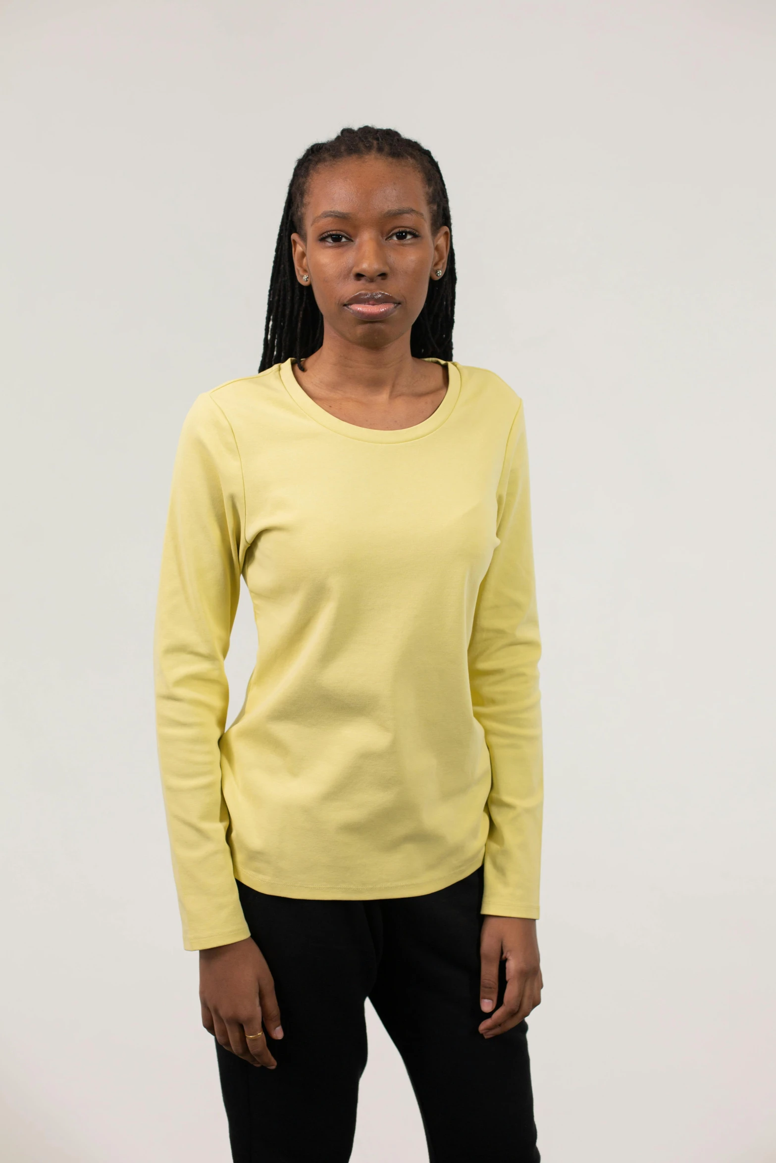 a woman in a yellow shirt and black pants, full product shot, wide neck, wearing a light shirt, no - text no - logo