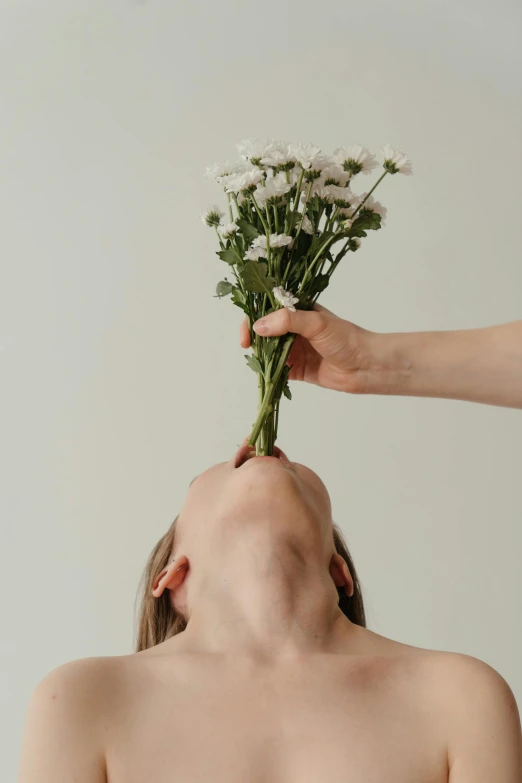 a woman holding a bunch of flowers over her head, trending on unsplash, aestheticism, couple kissing, minimalistic aesthetics, ignant, skincare